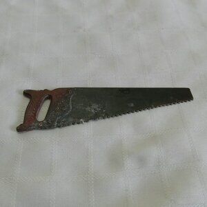 Fake toy shaped like a hand saw made of metal vintage and functional